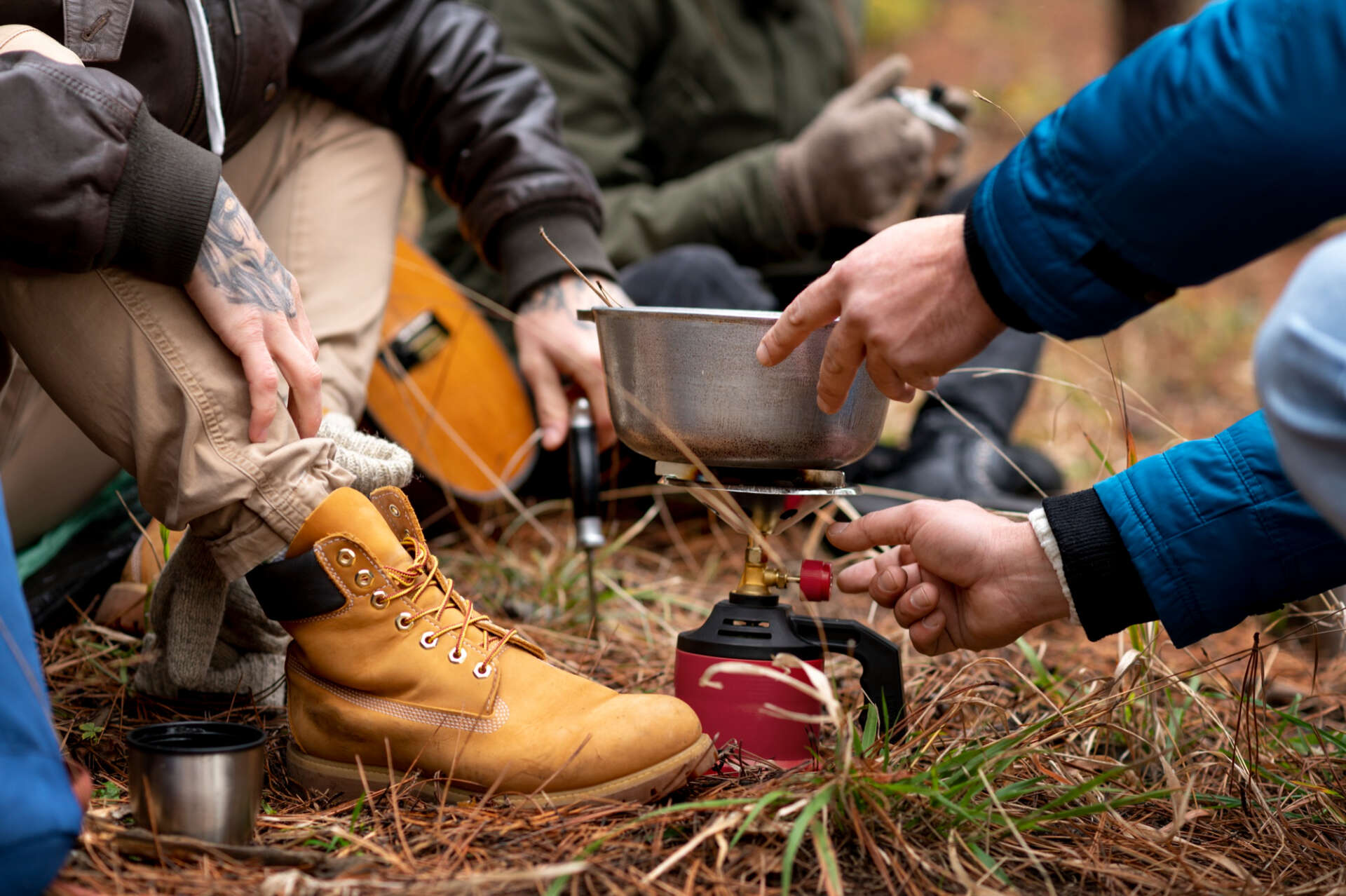 Kochen beim Wandern: Wanderer verwenden einen Gaskocher, um Essen zuzubereiten.